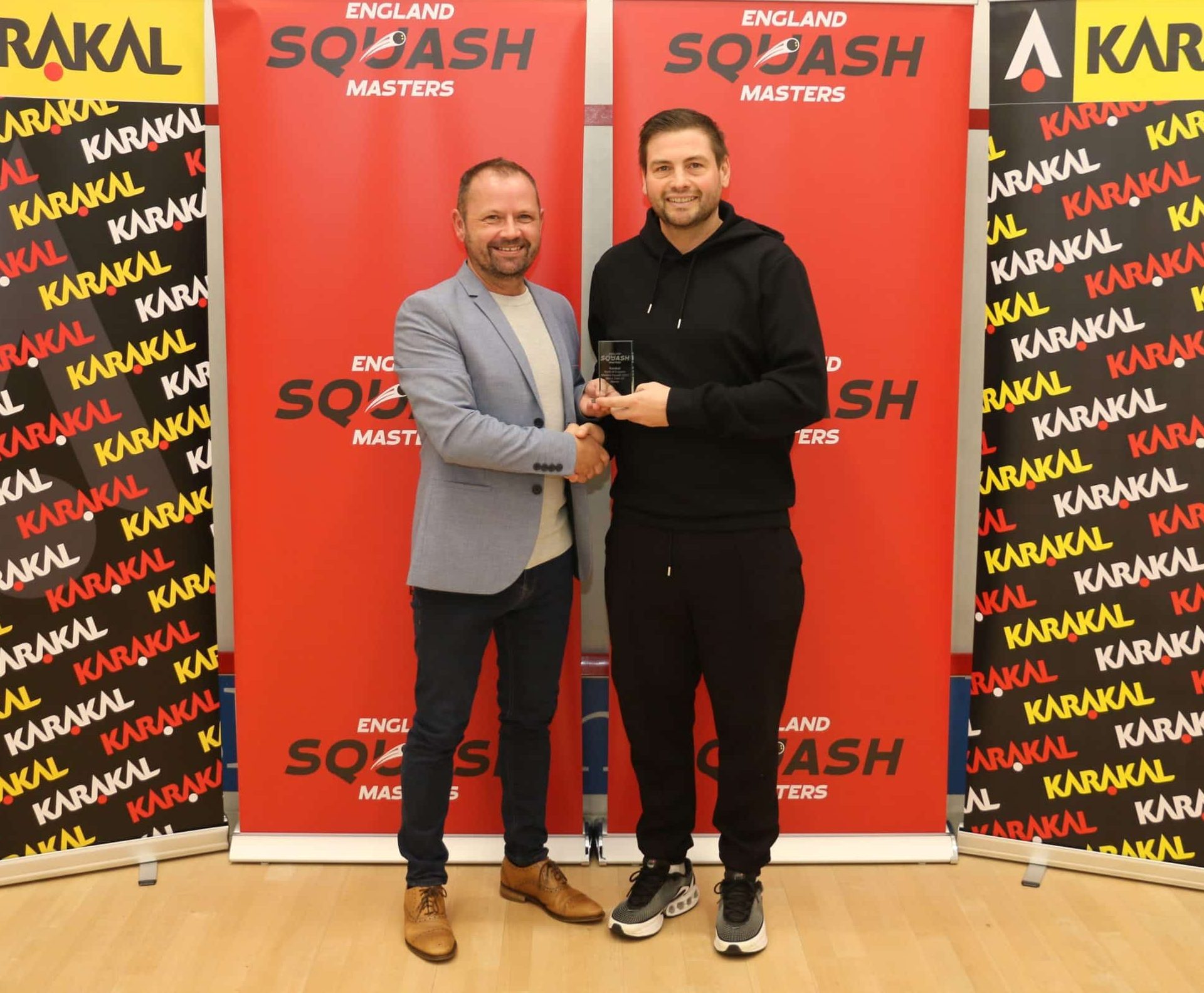 Lee Jemmett collecting his regional Masters trophy.